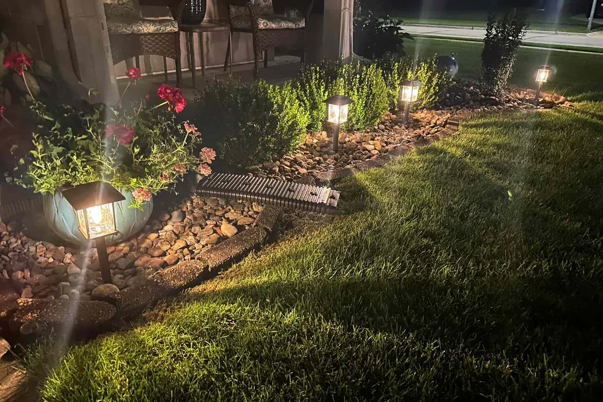 Residential garden lit by solar path lights at night