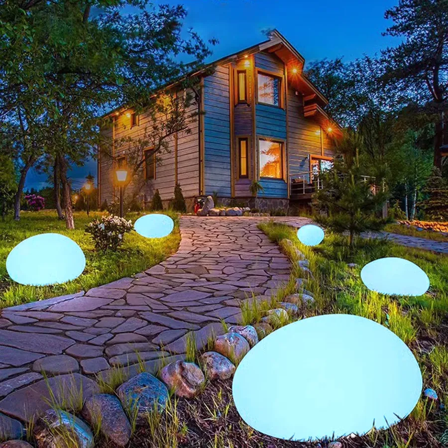 TerraGlow solar pebble lights glowing beside a stone path at night