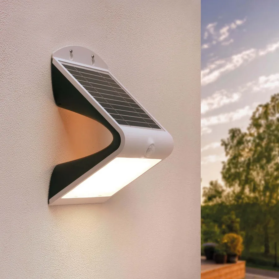 Arc modern solar wall light with motion sensor mounted on an exterior wall